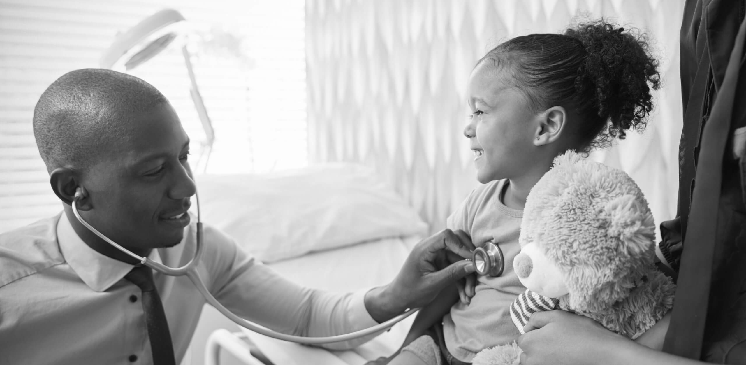 Mother Taking Daughter For Medical Exam In Doctors Office